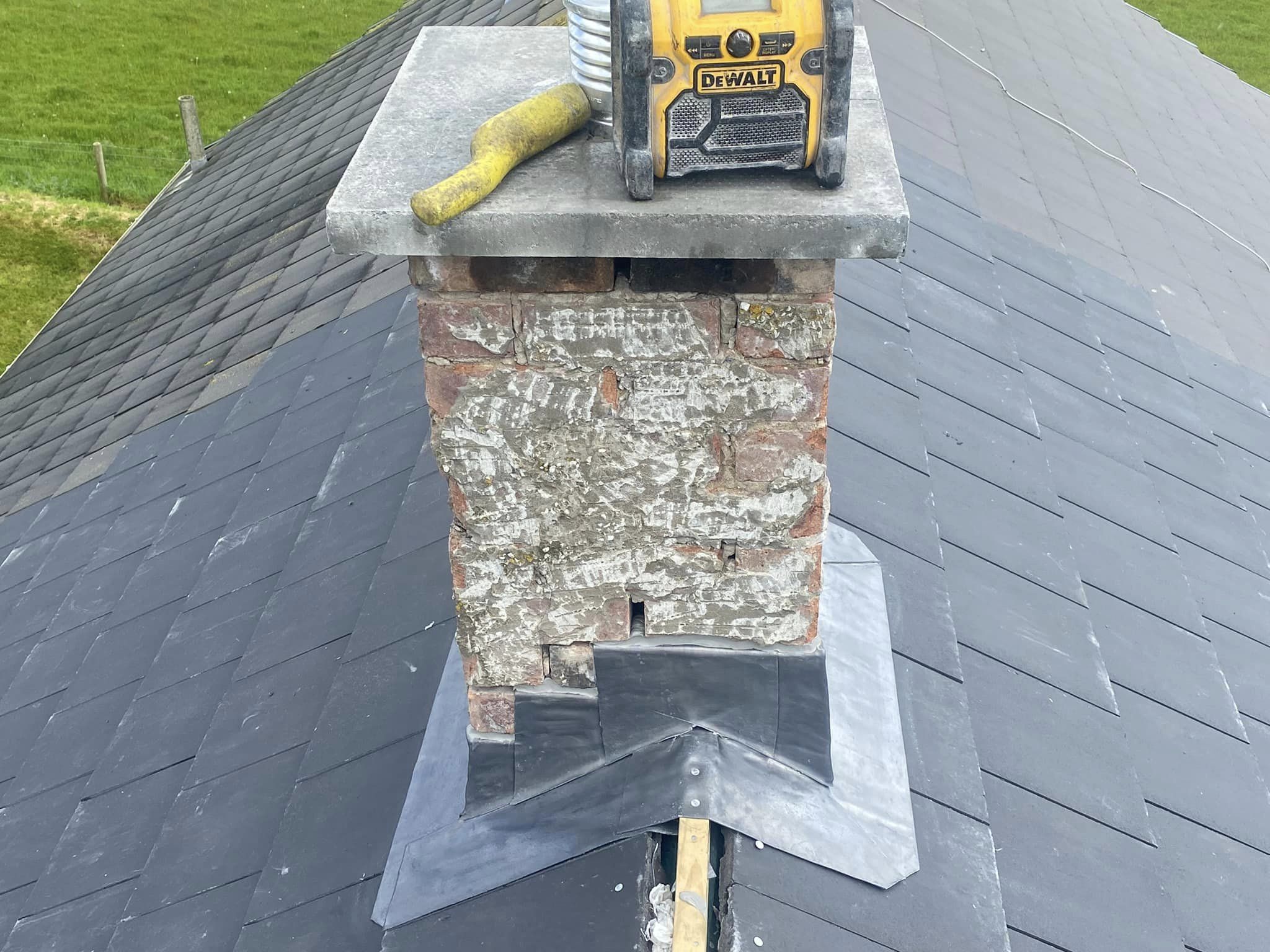 Lead flashing work around a chimney on a slate roof